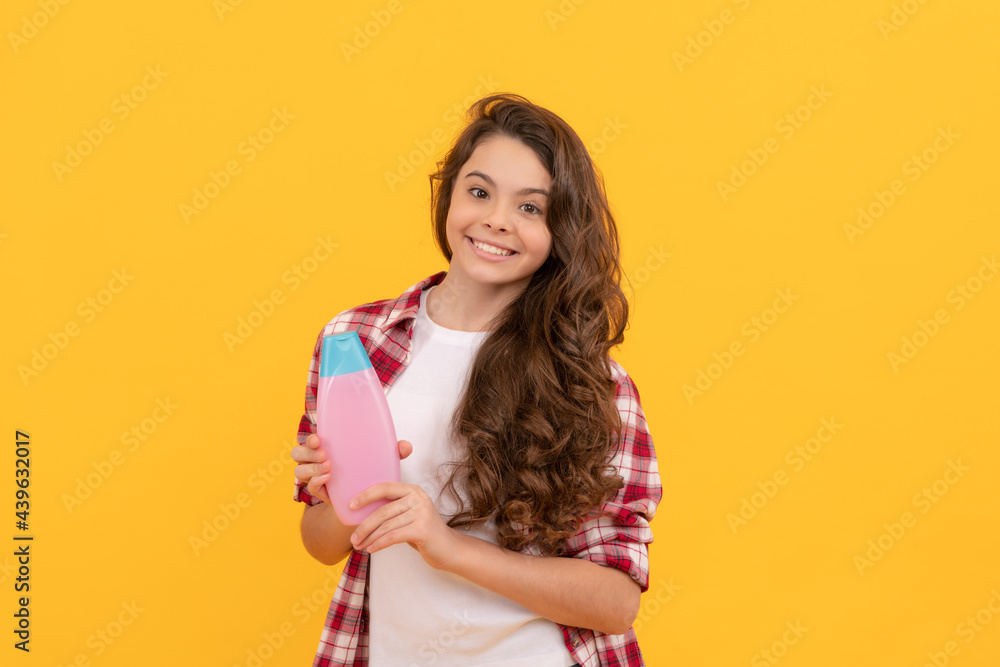 kid use shower gel. happy teen girl with shampoo bottle. shampooing hair in  salon. Stock Photo | Adobe Stock
