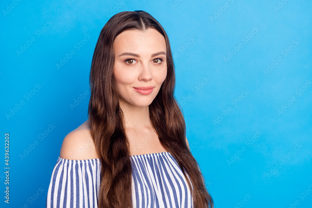 Photo of pretty charming young woman dressed striped outfit smiling empty space isolated blue color background Photo of pretty charming young woman dressed striped outfit smiling empty space isolated blue color background