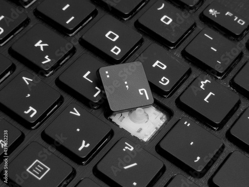 Close-up of broken button on laptop keyboard 