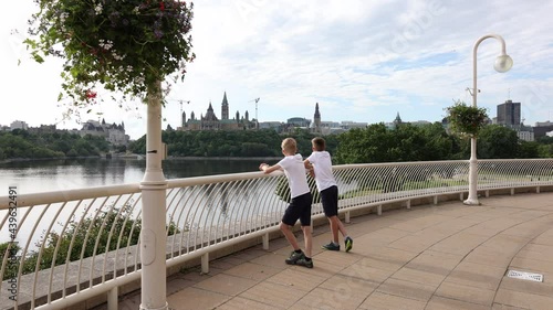 Boys look across the river from the Gatineau side at the Parliament of Canada photo