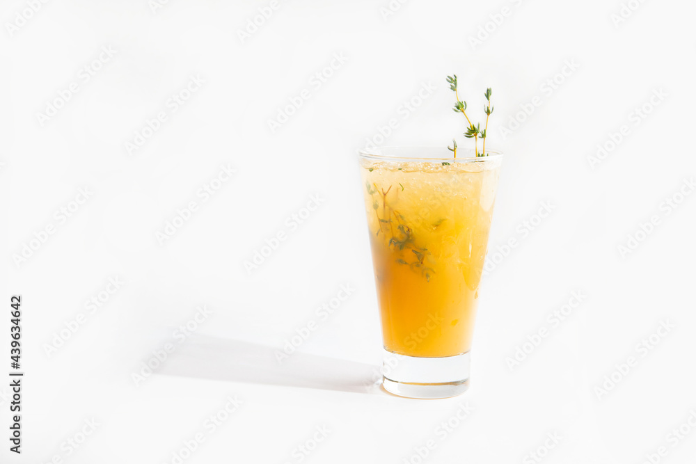 yellow cocktail in a glass with a sprig of greens. yellow cocktail in a glass with a sprig of greens.