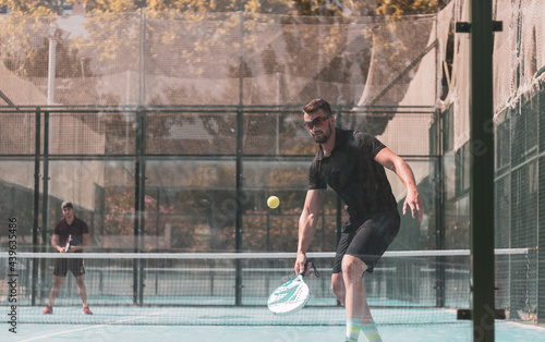 padel player playing a match in the open photo