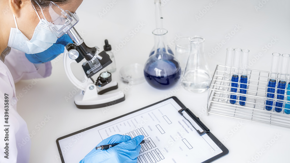 Fototapeta premium Scientist working with microscope for vaccine development in pharmaceutical research laboratory. Innovation Concept.