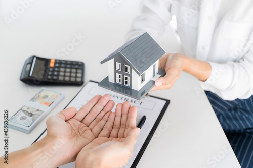 home loan insurance. .Real estate broker and client  sign contract insurance agreement document. Business meeting concept