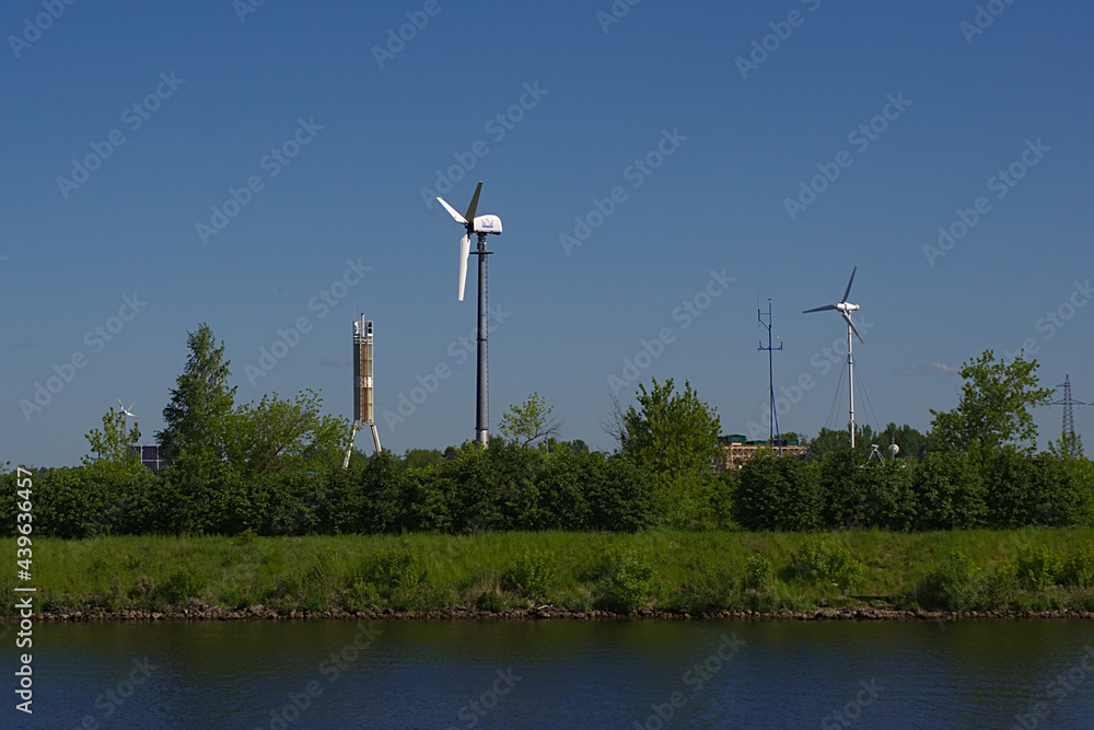 wind turbines on the bank of a large river