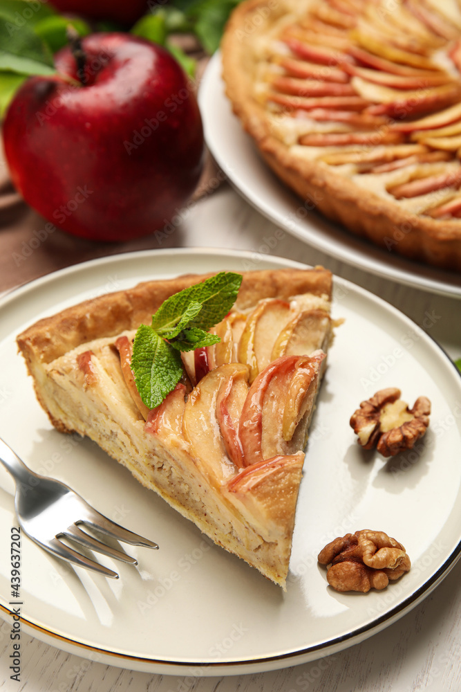 Slice of delicious apple pie on white wooden table Slice of delicious apple pie on white wooden table