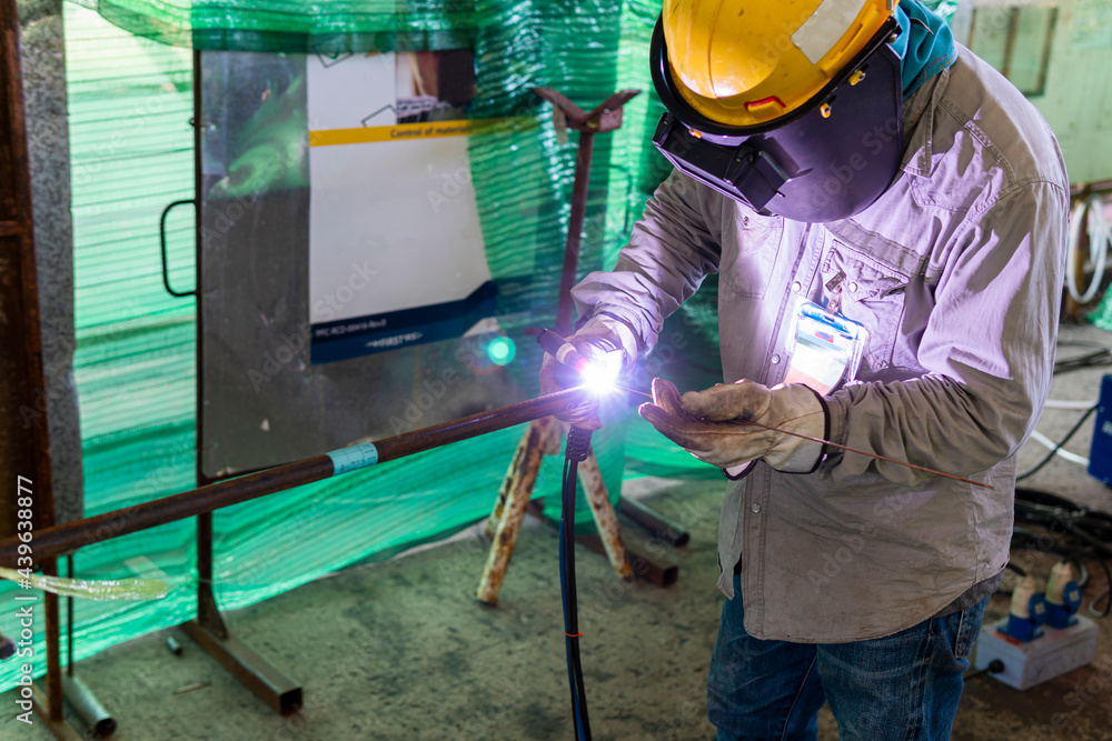 Welder is working welding pipe carbon with process Tungsten Inert Gas