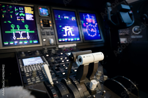 A typical dashboard panel in the cockpit of a private jet plane aircraft. Throttle control lever in focus.