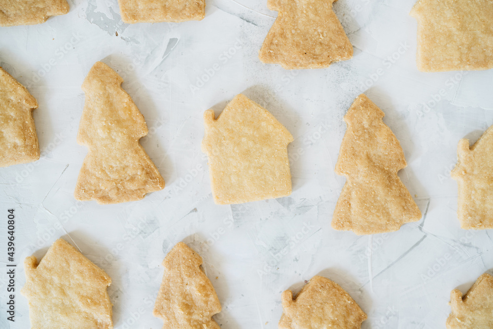 Flat lay of gingerbread with shape of christmas tree and houses Flat lay of gingerbread with shape of christmas tree and houses