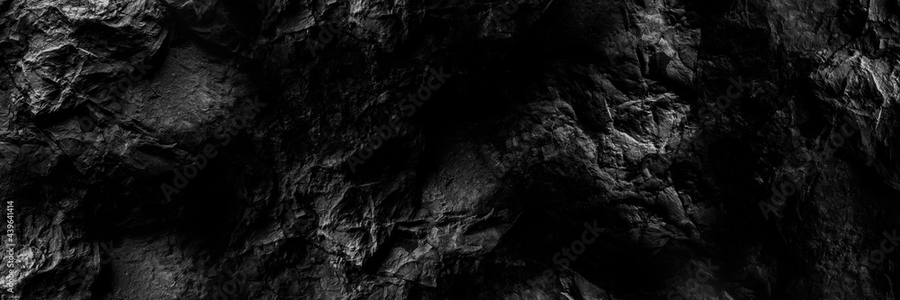 Black stone background. Black and white grunge background. Old black stone wall. Grunge banner. Dark gray stone background. Geometric stone pattern.