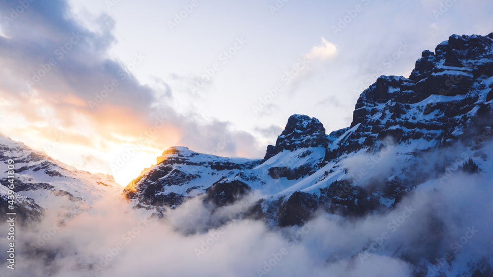 Bird’s eye view of breathtaking scenic ice snow peak on mountains on european north resort, scenery nature,  snow capped summit of rocks and hills on natural destinations wanderlust trip.