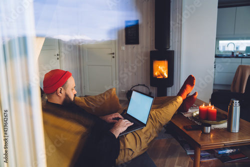 Man in north cottage with laptop photo