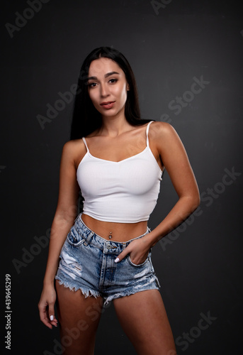 portrait of a young woman in the studio on a dark background