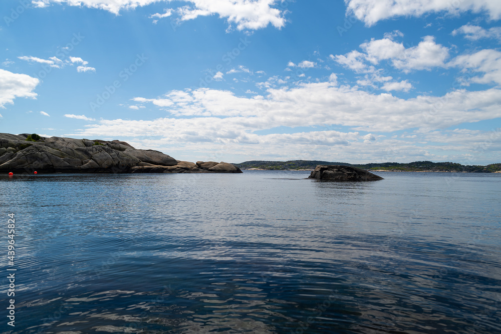 the beautiful coast of norway with its rock formations and blue water on a beautiful summer day