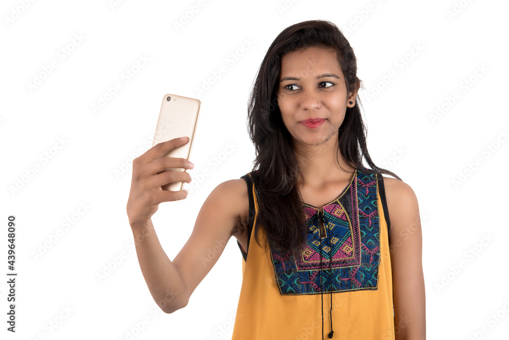 Portrait of a happy young girl using mobile phone isolated over white background Portrait of a happy young girl using mobile phone isolated over white background