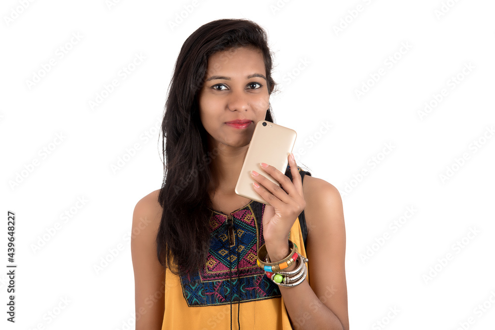 Portrait of a happy young girl using mobile phone isolated over white background Portrait of a happy young girl using mobile phone isolated over white background