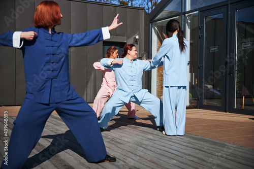 Group of women working out with tai chi
