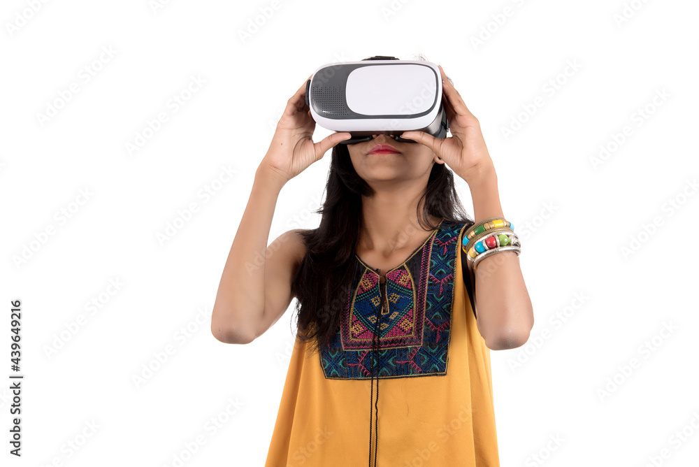 Beautiful girl looking though VR device. Young girl wearing virtual reality goggles headset. Beautiful girl looking though VR device. Young girl wearing virtual reality goggles headset.