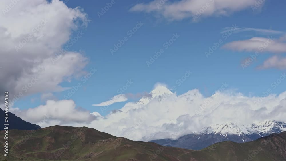 Timelapse Clouds swirl over a mountain valley, a snowy peak in the distance. Mustang, Nepal, Annapurna Timelapse Clouds swirl over a mountain valley, a snowy peak in the distance. Mustang, Nepal, Annapurna