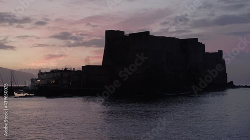 Aerial Drone footage view of Castle Dell’Ovo in Naples Italy seaport sea evening  // no video editing
 photo