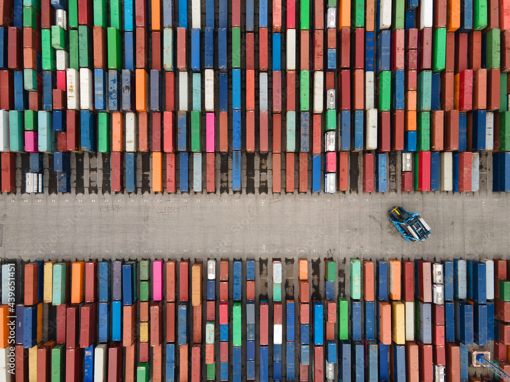 © Anna Berkut/Stocksy - industrial robot working with shipping containers in the port © Anna Berkut/Stocksy - industrial robot working with shipping containers in the port