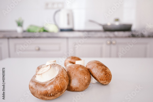 brown mushrooms on a white kitchen table. background copy space photo