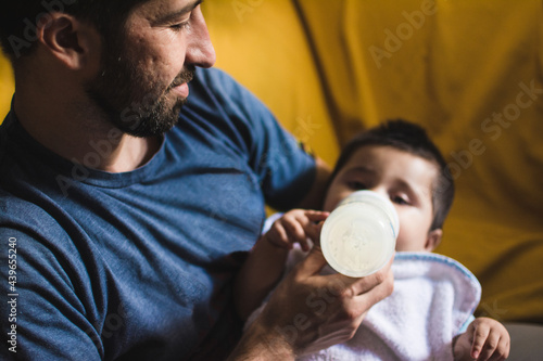 Sweet feeding moment of dad and baby boy photo