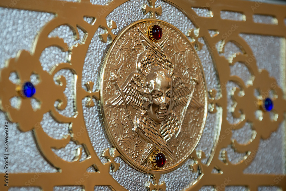 Bas-relief with an angel in gold / golden angel