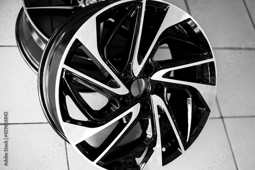Black alloy wheels on a car, close-up. Purchase and replacement of autodisks