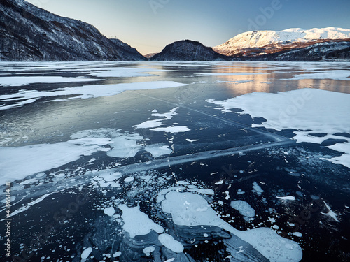 Greenhouse gases bubble up to freezing icy surface of Arctic water causing climate change photo