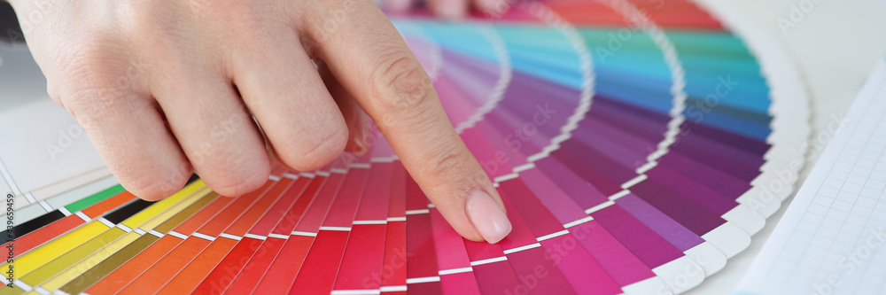 Designer holding color swatch at desk in office closeup - obrazy, fototapety, plakaty 
