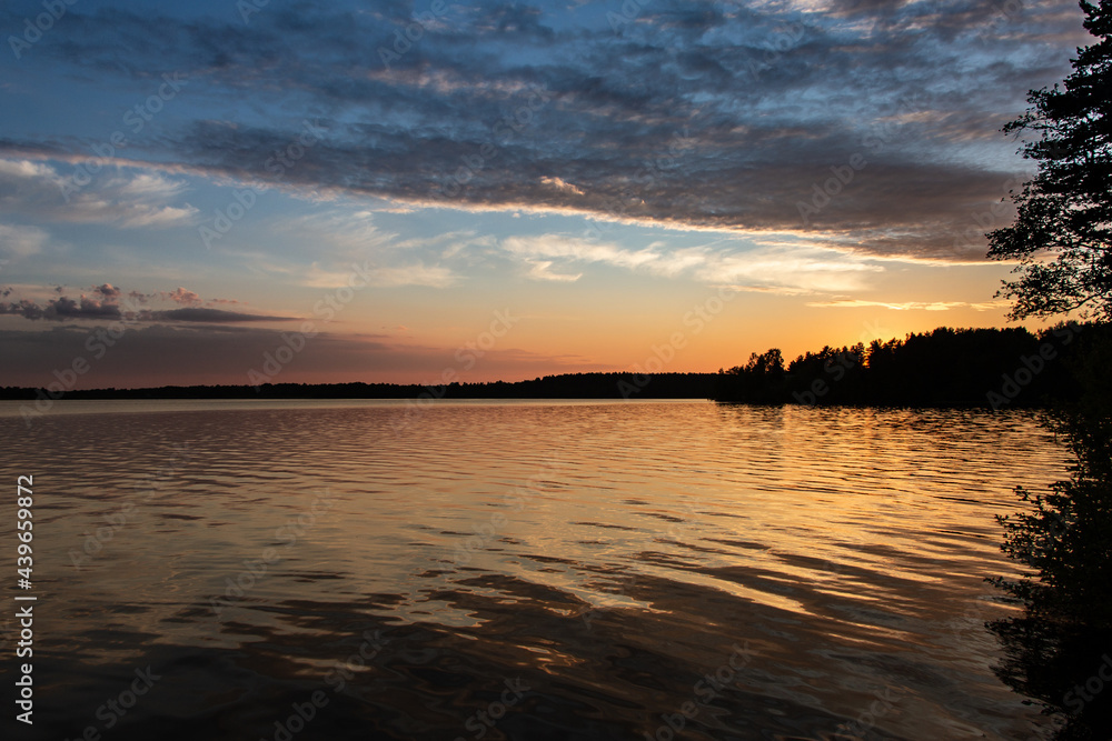 Golden sunset on the lake in summer