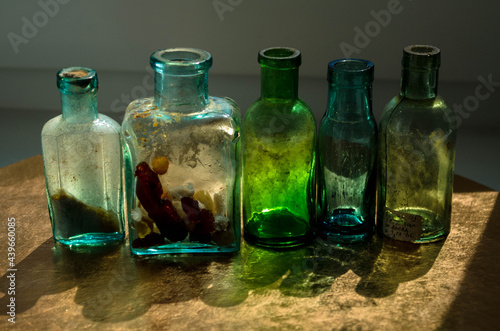 
Old glass bottles stand on the windowsill