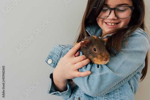 Girl holding guinea pig.  photo