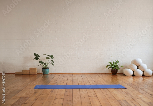 Yoga mat lying on wood floor in a yoga studio