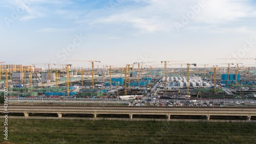 Aerial Flight Over a New Constructions Development Site with High Tower Cranes Building Real Estate. Heavy Machinery and Construction Workers are Employed. Xiongan new area of Beijing china.