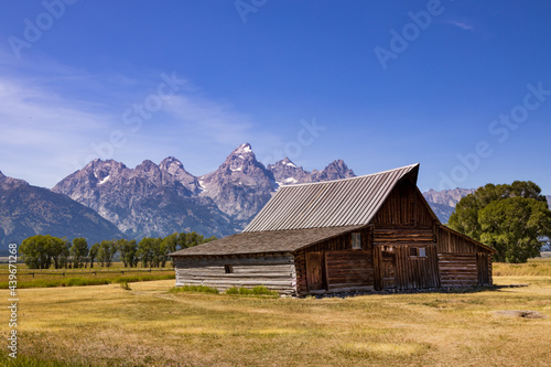 Wooden barn with Grand Teton mountain range in background