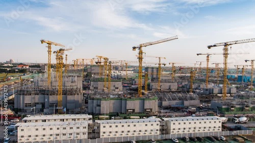 Aerial Flight Over a New Constructions Development Site with High Tower Cranes Building Real Estate. Heavy Machinery and Construction Workers are Employed. Xiongan new area of Beijing china.
