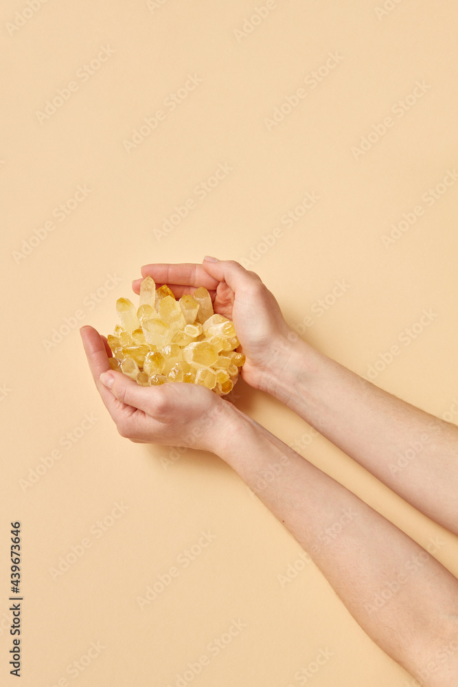 Woman holding orange crystal Woman holding orange crystal