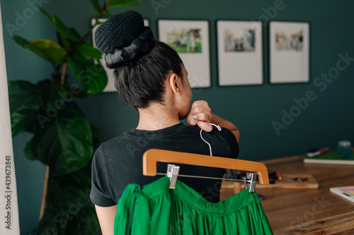 Back view girl holding a green folkloric Mexican skirt