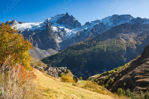 Ecrins National Park with the village of Le Chazelet and La Meije peak and glacier in Autumn. Hautes-Alpes, French Alps, France photo