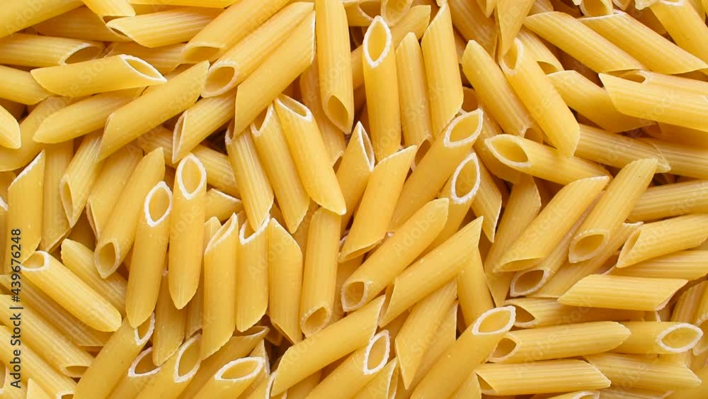 Raw whole dried Penne rigate pasta Raw whole dried Penne rigate pasta