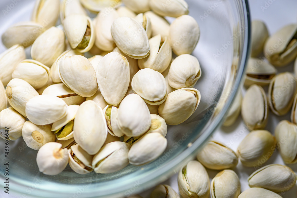 Close-up top view a pile of nut it has a white nutshell dry and hard of Pistachio, Pistache or Pistacia vera in a bowl food delicious salty snack Close-up top view a pile of nut it has a white nutshell dry and hard of Pistachio, Pistache or Pistacia vera in a bowl food delicious salty snack