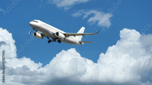 Zoom photo of passenger plane flying above deep blue cloudy sky