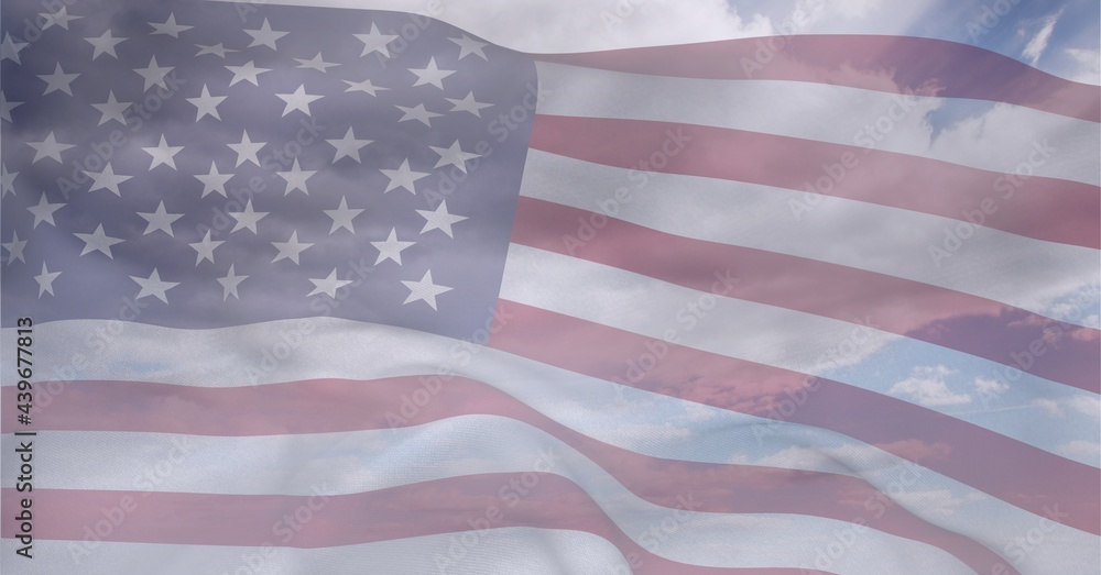Composition of billowing american flag over cloudy blue sky Composition of billowing american flag over cloudy blue sky