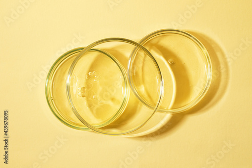 Top view of the petri dish staying on each other with bubbles inside.Warm yellow background with copy space.Mockup concept,place for design. photo