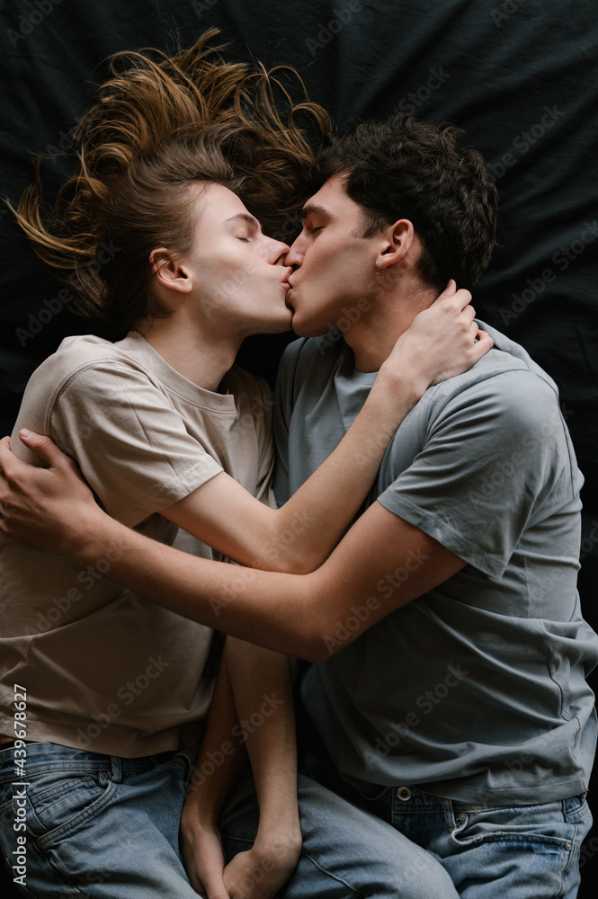 Gay couple kissing on bed Gay couple kissing on bed