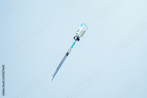 Syringe drawing Covid-19 vaccine from vial photo