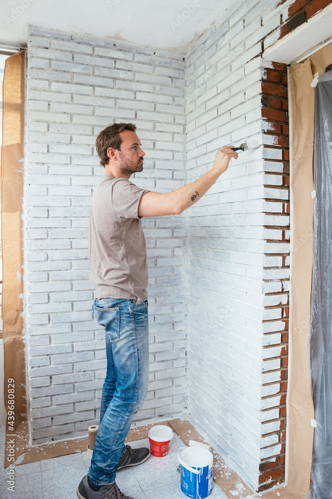 Man painting wall at home Man painting wall at home
