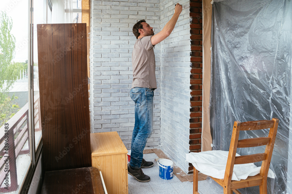 Man painting wall at home Man painting wall at home
